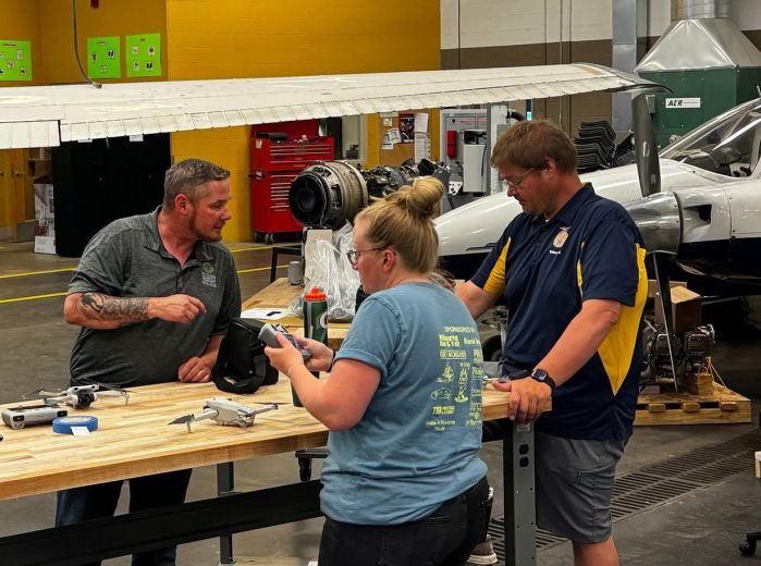Zack helps out two teachers with drones in the Aircraft lab