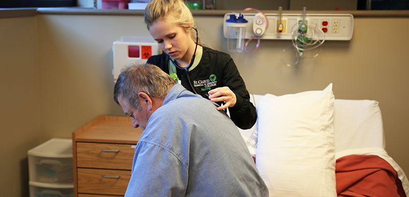 student assessing volunteer patient