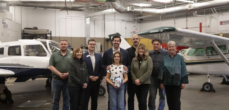 group photo of legislators and SCTCC folks in front of the airplanes