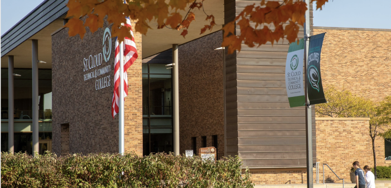 Front of SCTCC in fall with students stepping on sidewalk