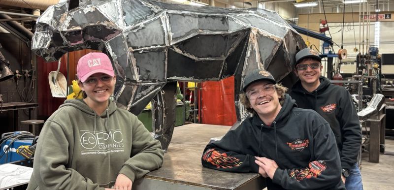 Jasslyn, Logan, and Josh posing in front of the panther before it heads to All Pro 
