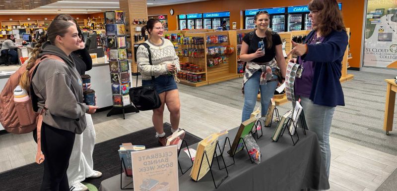 Mary talking to four students about banned books