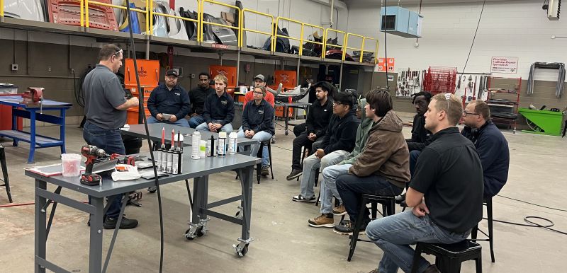 students listening to presenter in a large lab
