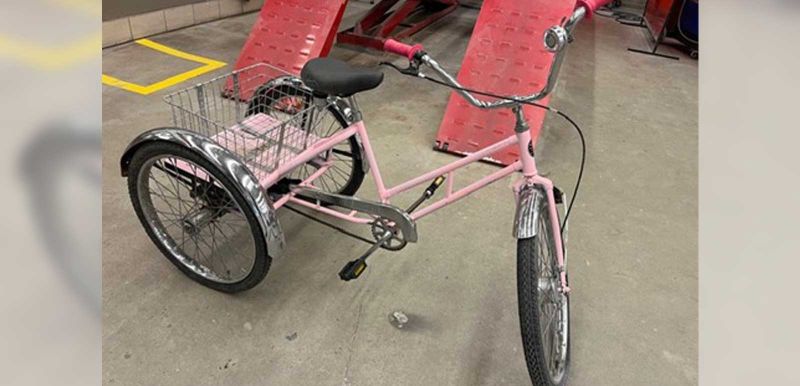 a pink tricycle with a basket