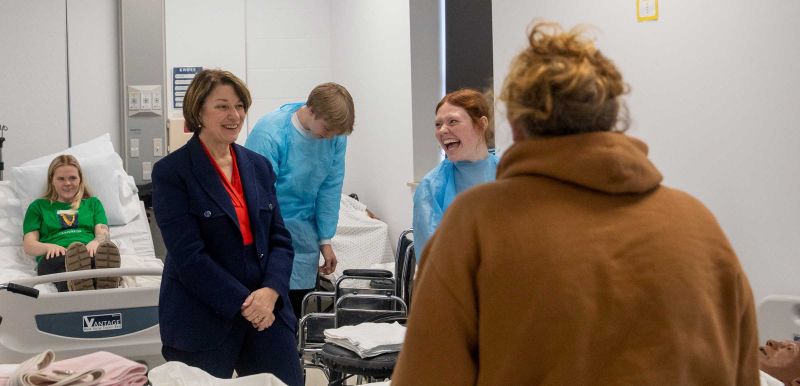 Amy Klobuchar chats with students and instructors in the nursing lab