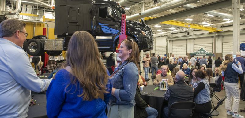 Large group of folks at brewlash with a semi up on a lift