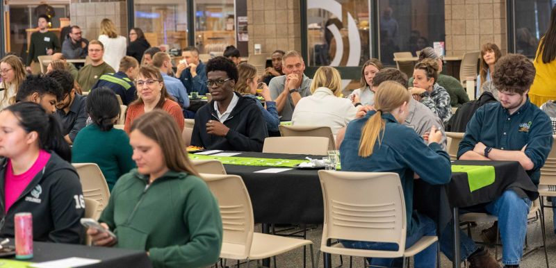 large group of people seated at tables during breakfast