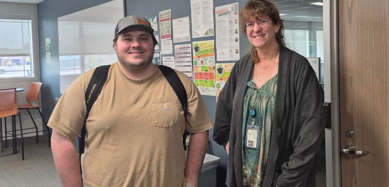John and Mary standing side by side in the library