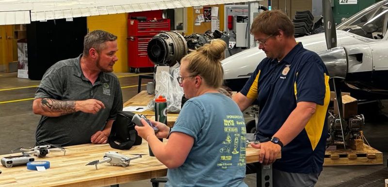 Zack helps out two teachers with drones in the Aircraft lab