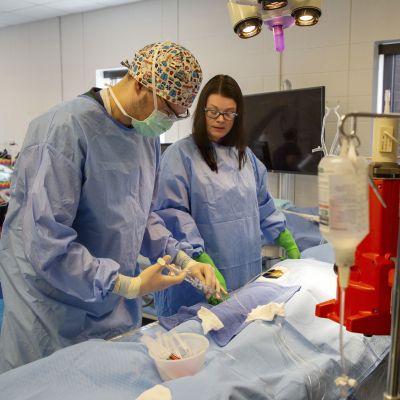 CVT instructor guides student in full gear in practice procedure
