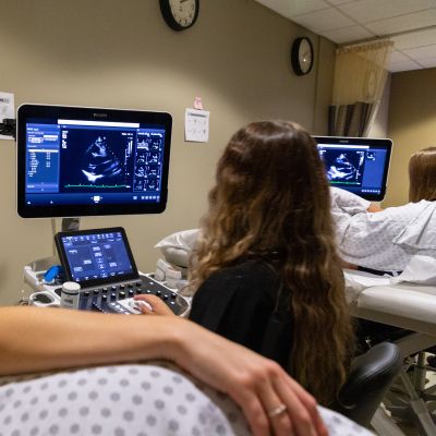 two echo students scanning, with scans on screens