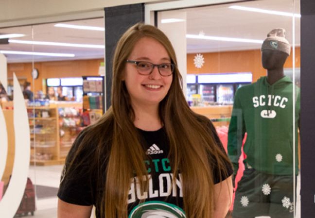 Jasmine Pelzer in front of poster she made