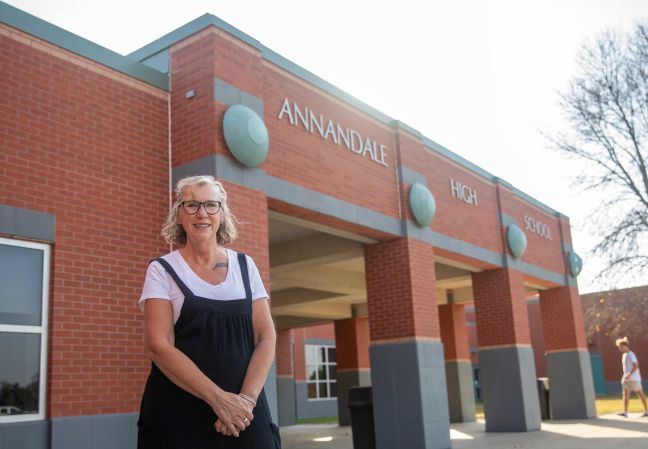 Wendy standing in front of the Annandale High School