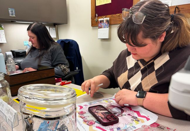 Molly and Carol work on diamond art at a desk
