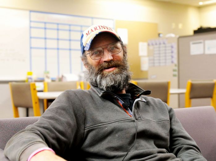 chad sitting in a chair in the veterans center, looking relaxed