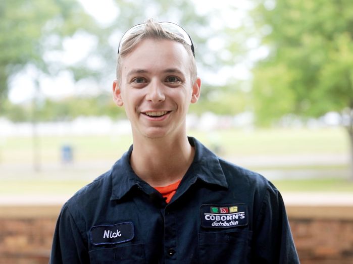 Nick Lamperes smiling with trees in background
