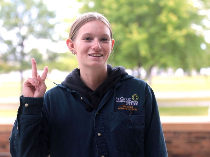 Samantha give a peace sign