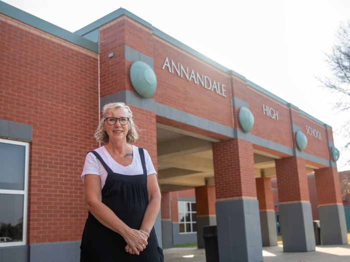 Wendy standing in front of the Annandale High School