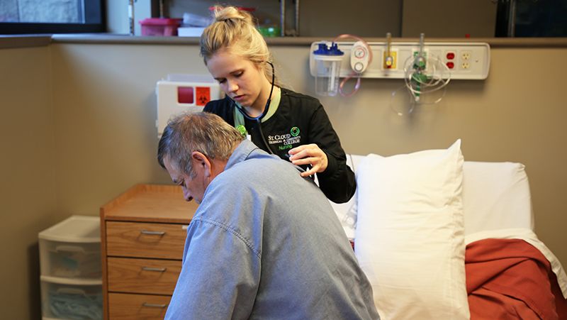 student assessing volunteer patient
