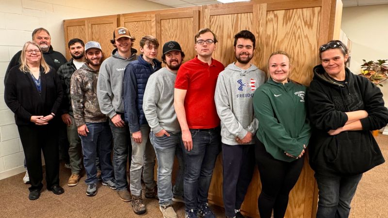 Line of Carpentry students in front of closet