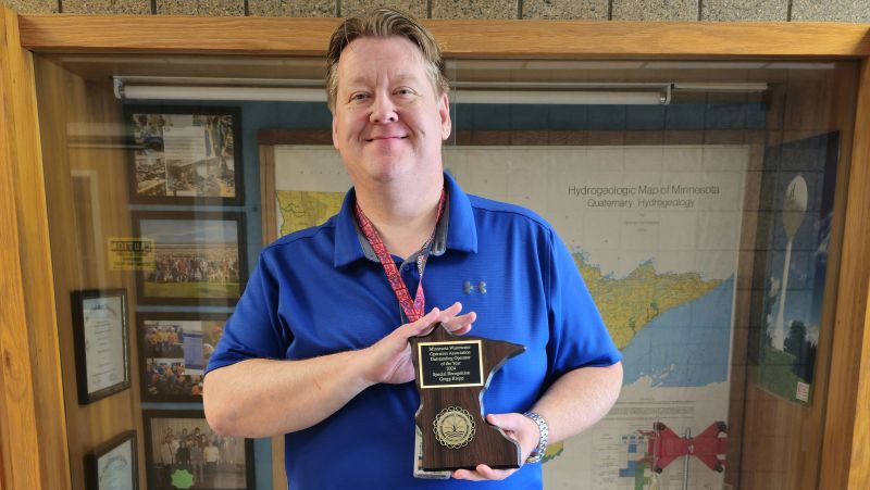 Gregg Kropp holding award