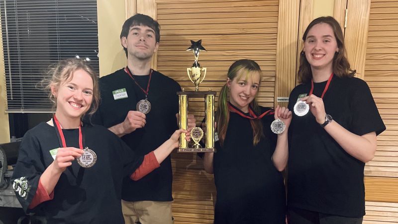the four MKAD students who won the challenge with medals and a trophy