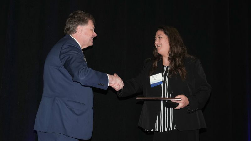 kelly crue accepted an award from chancellor olson