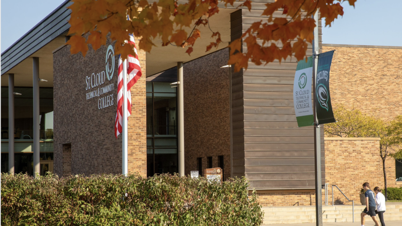 Front of SCTCC in fall with students stepping on sidewalk