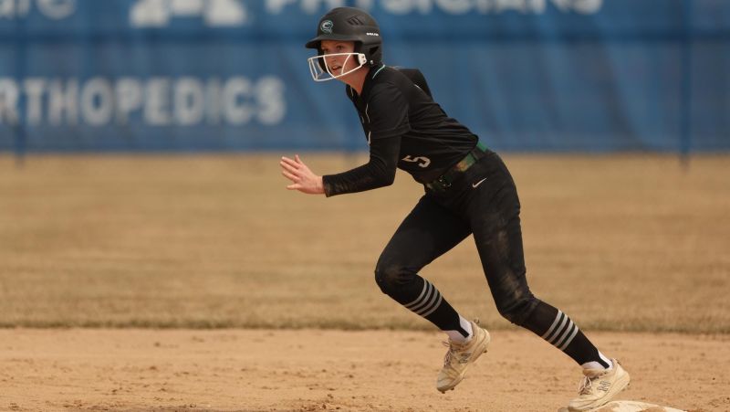 Sami Petzel in softball uniform ready to run bases