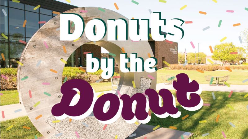 Donuts by the Donut written over Emblem of Unity outside main entrance with sprinkles