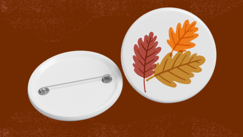 a pin button with fall leaves on it