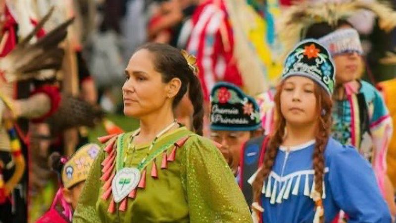 Native American Woman in traditional dress dancing