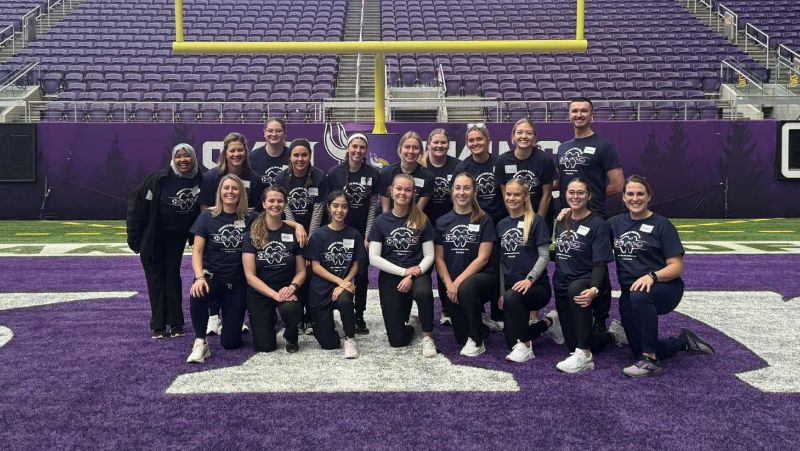 Dental hygiene students in three rows on the vikings field