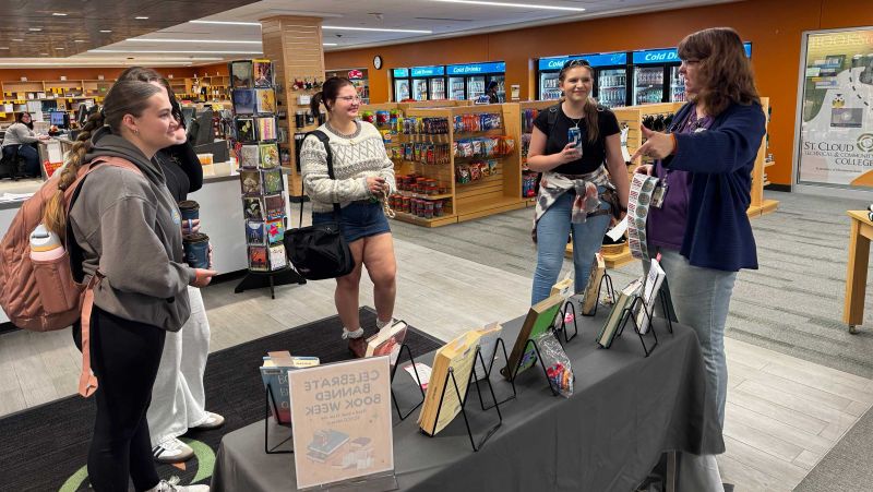 Mary talking to four students about banned books