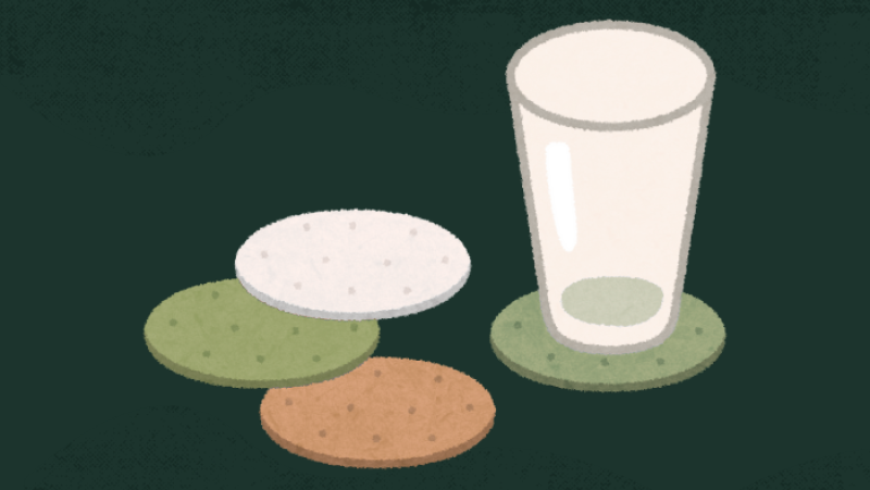 a cup sitting on a coaster with three coasters next to it