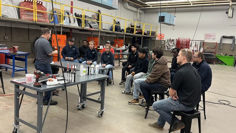 students listening to presenter in a large lab