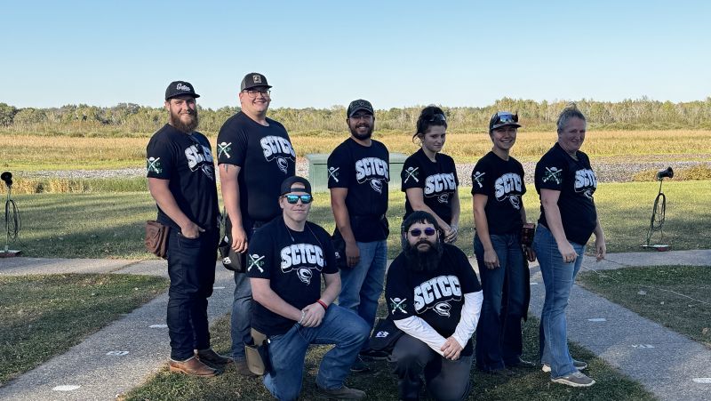 Trap team posing for the camera in two rows