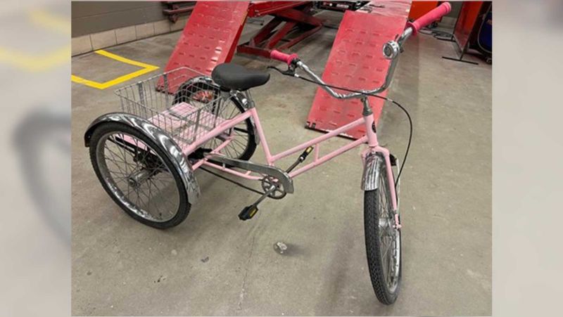 a pink tricycle with a basket