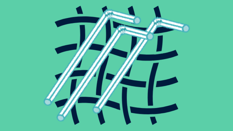 Plastic straws on a woven background