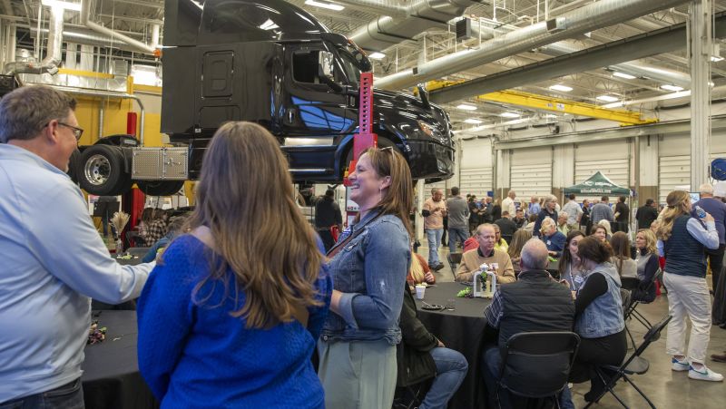 Large group of folks at brewlash with a semi up on a lift
