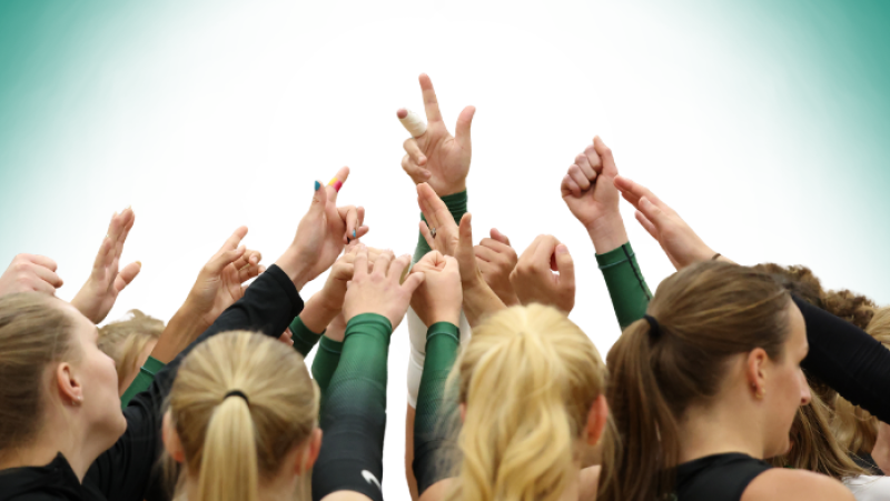 Volleyball players teamed up and cheering together
