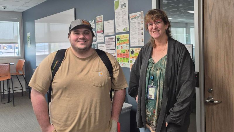 John and Mary standing side by side in the library