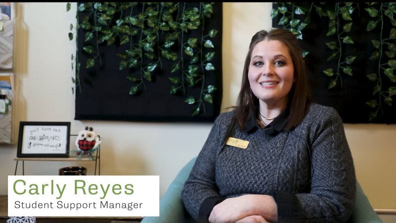 screen grab of Carly smiling in her office