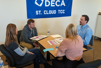 4 people sitting around table