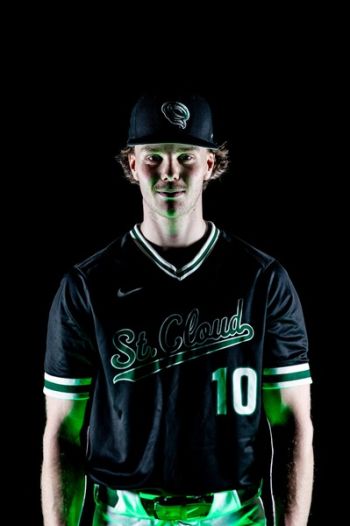 Griffin Dosan in a moody background with green lighting