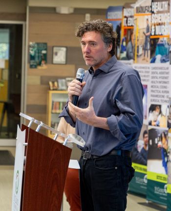 Aric Putnam at a podium speaking