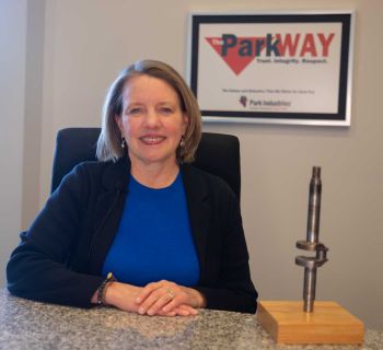 Joan Schatz in a chair with a ParkWay sign behind her