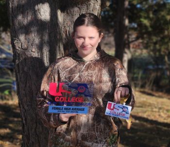 Jordan Lewis holding awards