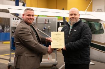 Zack shaking hands with Scott receiving the official certificate