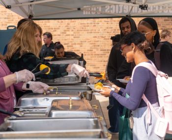 President Kloos serving students food at Grill and Chill